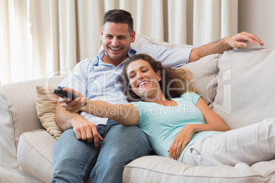 Couple watching TV in living room