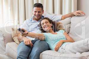 Couple watching TV in living room