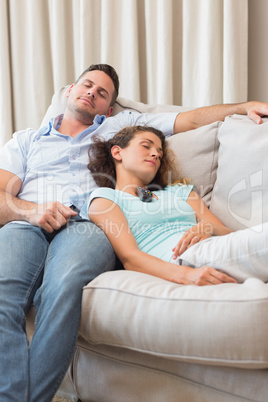 Couple sleeping on sofa