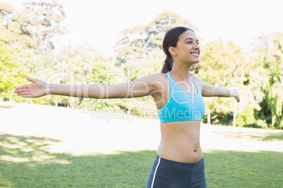 Smiling fit woman in park