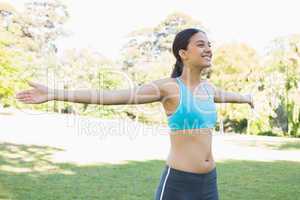 Smiling fit woman in park