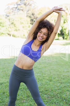 Smiling woman exercising in park