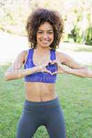 Sporty woman showing heart shape