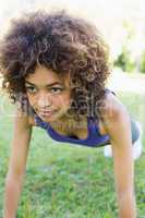 Dedicated woman doing push ups in park