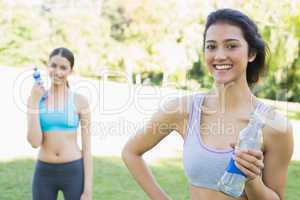 Beautiful sporty women holding water bottles