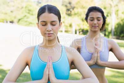 Women meditating in park