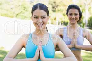 Smiling women exercising in park