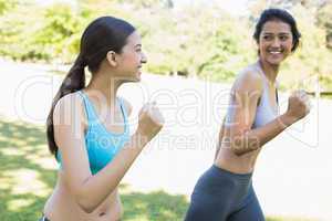 Happy sporty women jogging