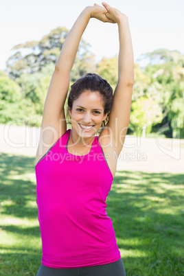 Young woman stretching at park