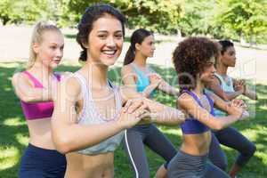 Beautiful woman exercising with friends