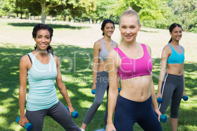 Sporty women exercising with weights