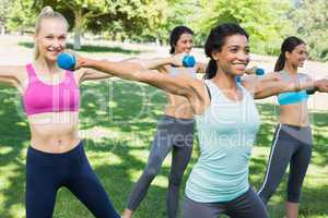 Sporty women lifting hands weights