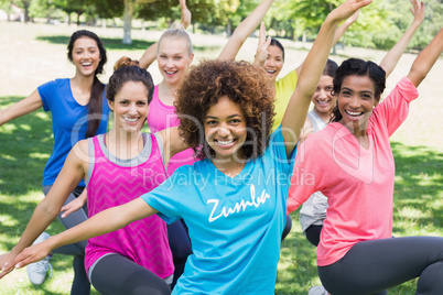 Women performing fitness dance in park