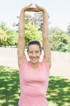 Woman doing stretching exercise at park