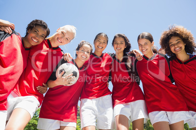 Female soccer team against clear blue sky