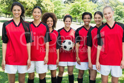 Happy female soccer team at park
