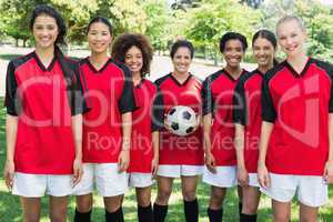 Happy female soccer team at park