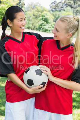 Female soccer players looking at each other