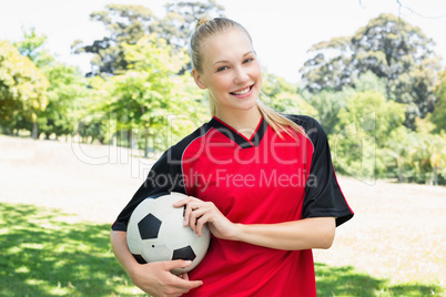 Confident female soccer player at park