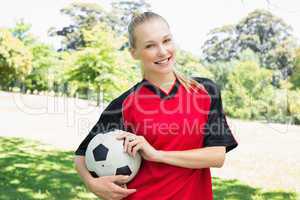 Confident female soccer player at park