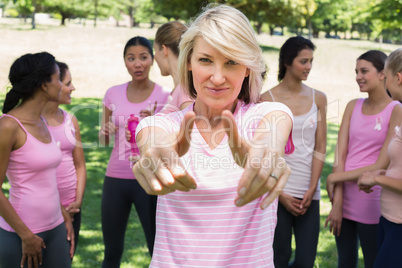 Woman gesturing thumbs up during breast cancer awareness