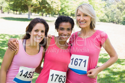 Happy women participating in breast cancer marathon