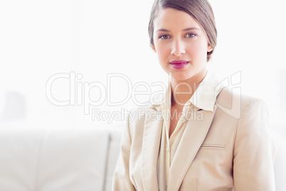 Young businesswoman sitting on sofa looking at camera
