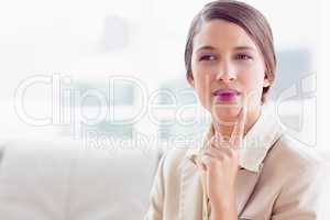 Thinking businesswoman sitting on sofa