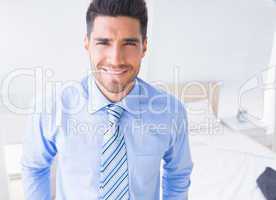 Handsome businessman smiling at camera