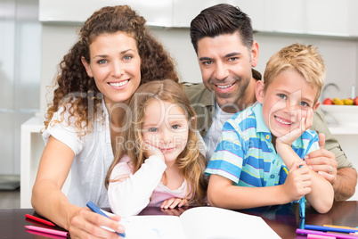 Parents colouring with their children at the table