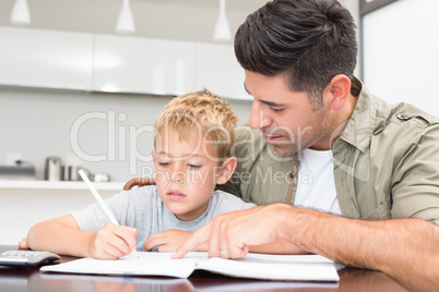 Father helping son with his math homework