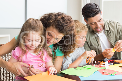 Cheerful family doing arts and crafts together at the table