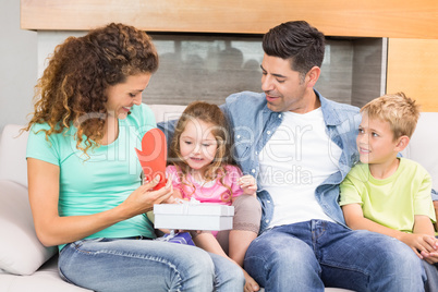 Happy family sitting on sofa celebrating a birthday