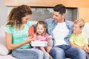 Happy family sitting on sofa celebrating a birthday