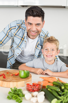 Smiling father showing his son how to prepare vegetables