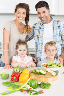 Happy family preparing vegetables together