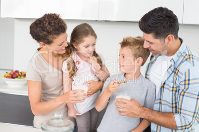 Happy family having cookies and milk