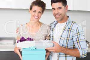 Cheerful woman holding many gifts from her partner