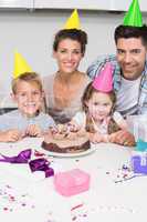 Smiling young family celebrating a birthday together