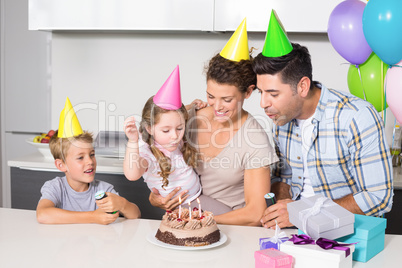 Happy young family celebrating a birthday together