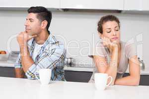 Unhappy couple having coffee not talking