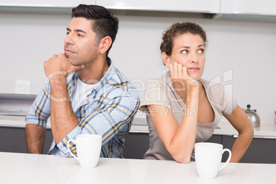 Unhappy couple having coffee not speaking