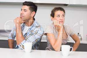 Unhappy couple having coffee not speaking