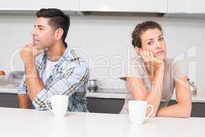 Troubled couple having coffee not talking