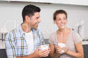 Attractive couple sitting having coffee together