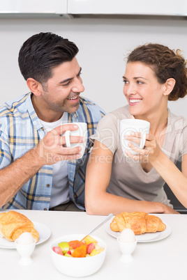 Attractive couple sitting having breakfast together