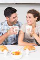 Attractive couple sitting having breakfast together