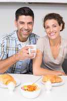 Smiling couple sitting having breakfast together