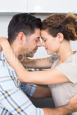 Romantic couple hugging with eyes closed