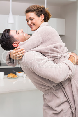 Man lifting and hugging his partner in the morning